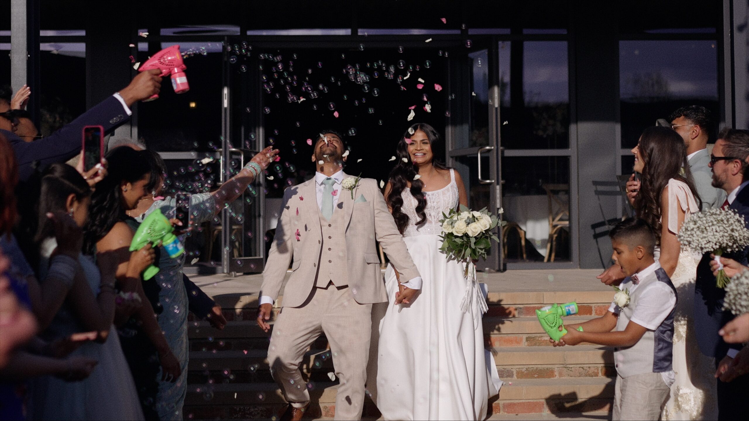 couple during confetti/bubble walk at Grangefields