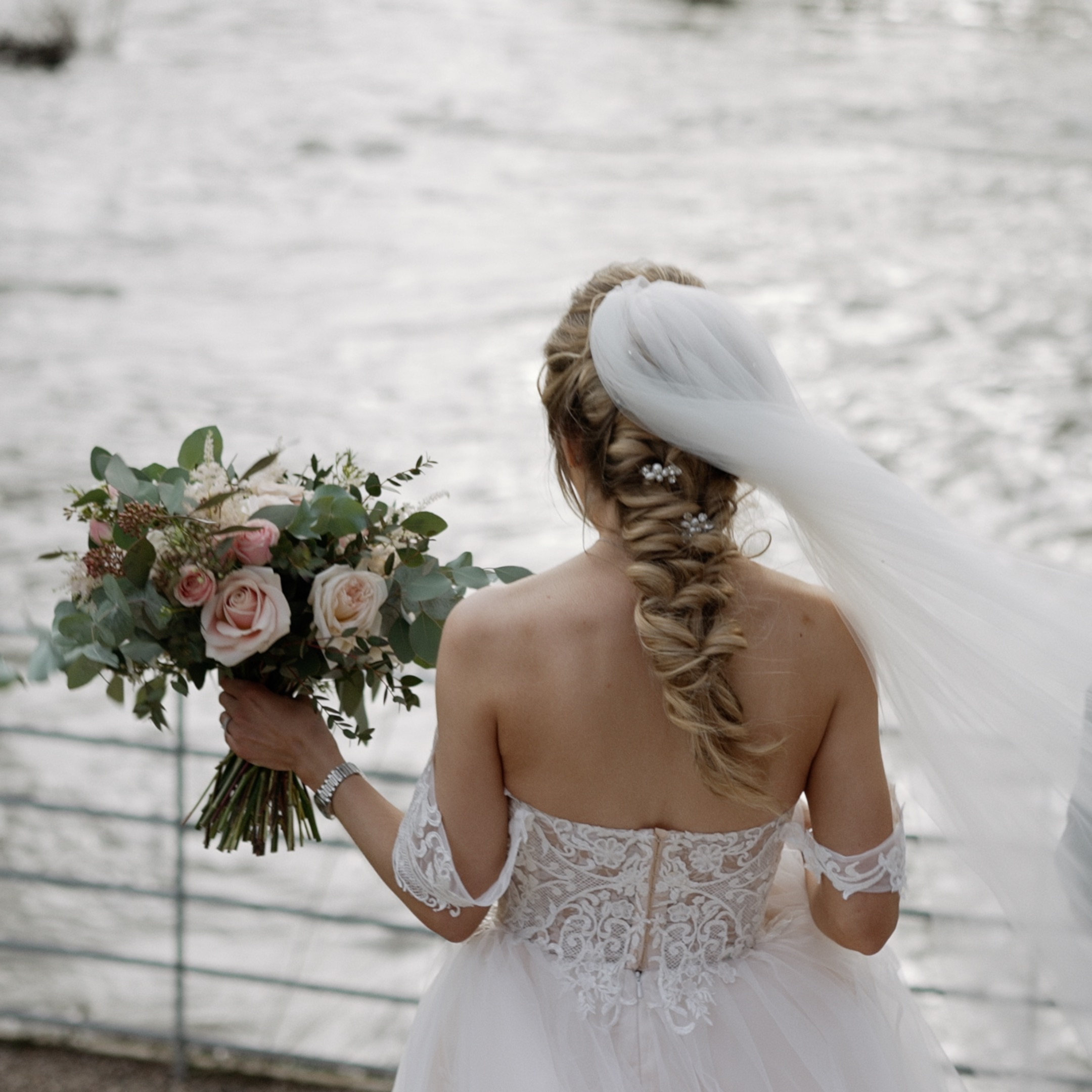 Bride walking on riverside at West Mill