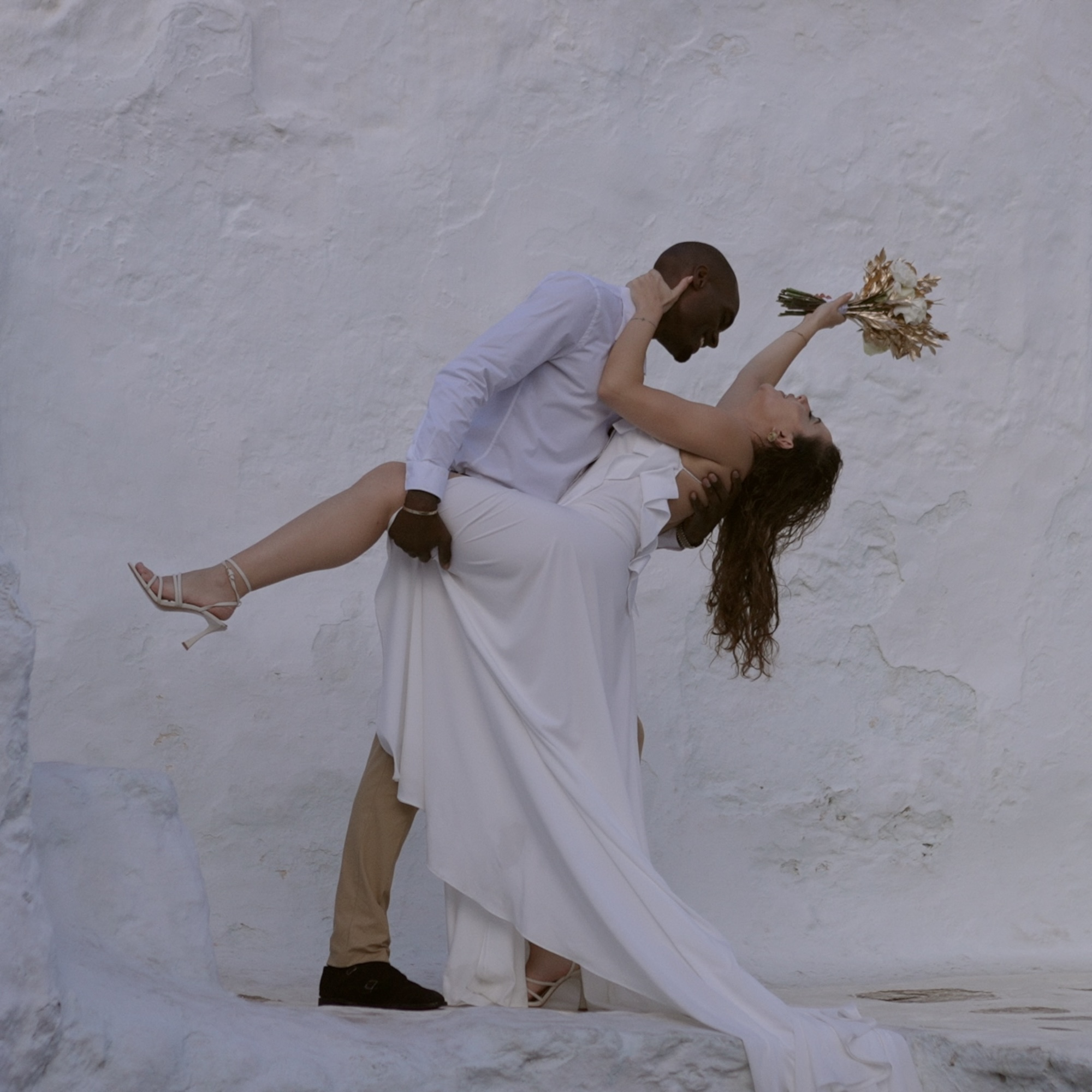 Bride and groom posing for a photo in Mykonos
