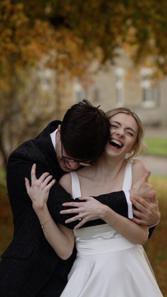 Groom hugging laughing bride at the Great Barn