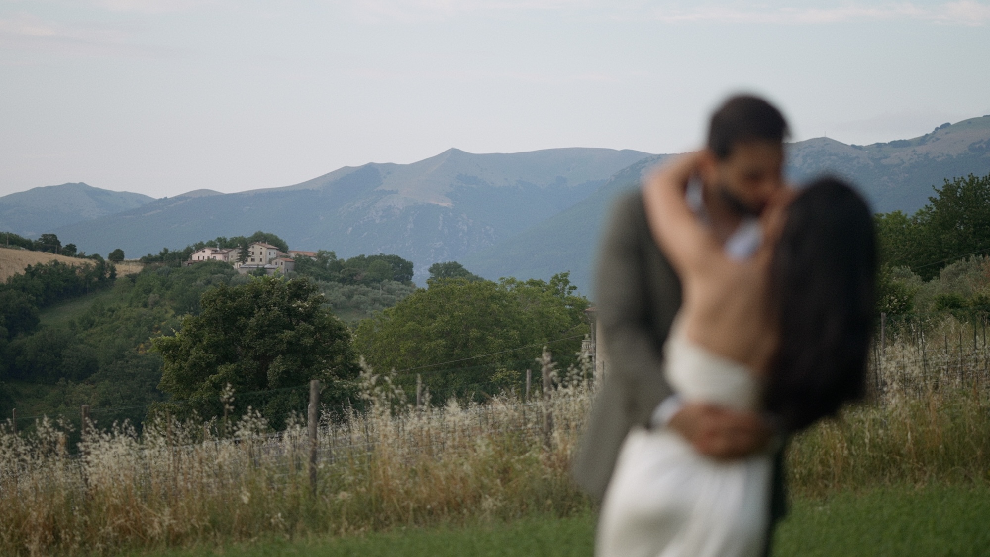 Bride and groom kissing near Castello Borgo Panicaglia in Umbria, Italy