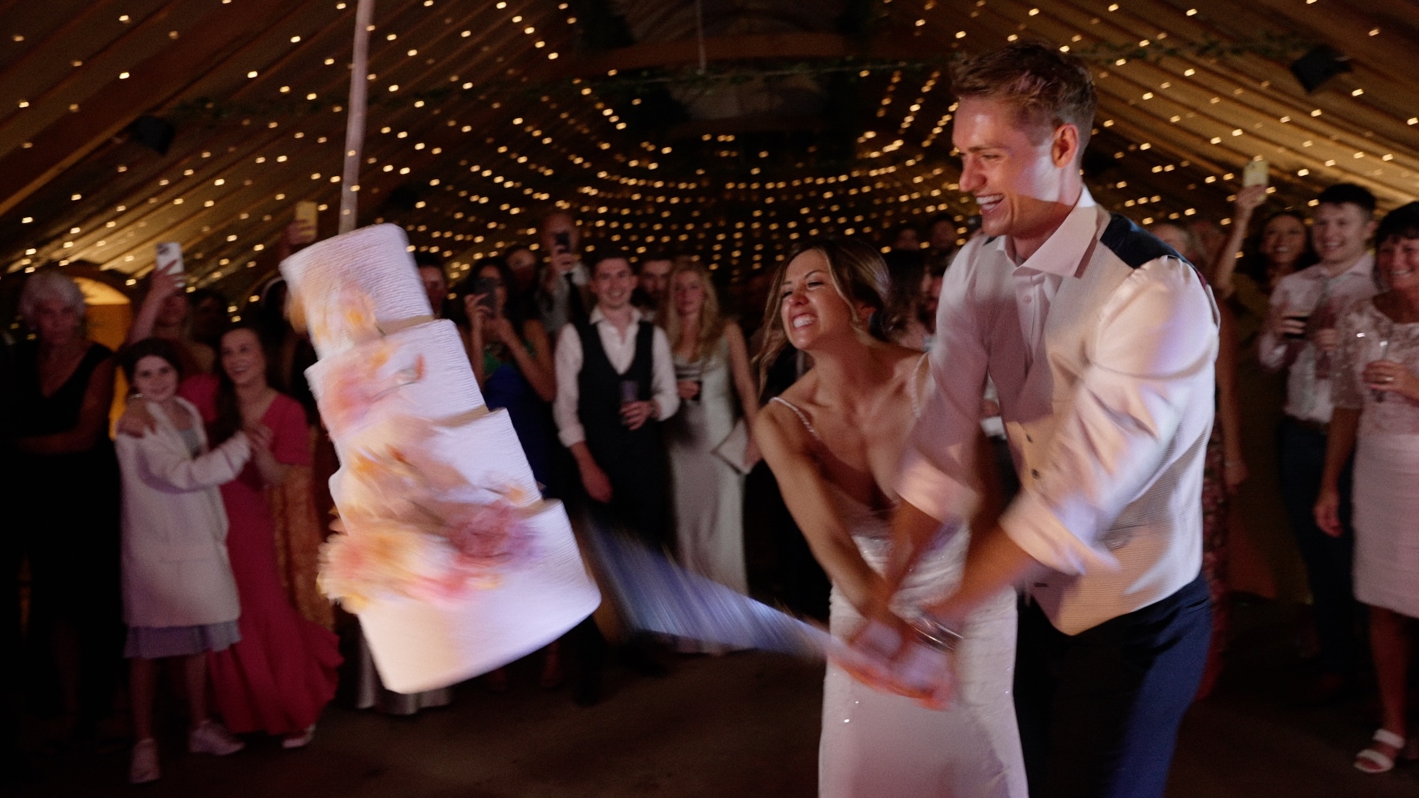 Bride & Groom smashing Pinata at Thorpe Garden wedding